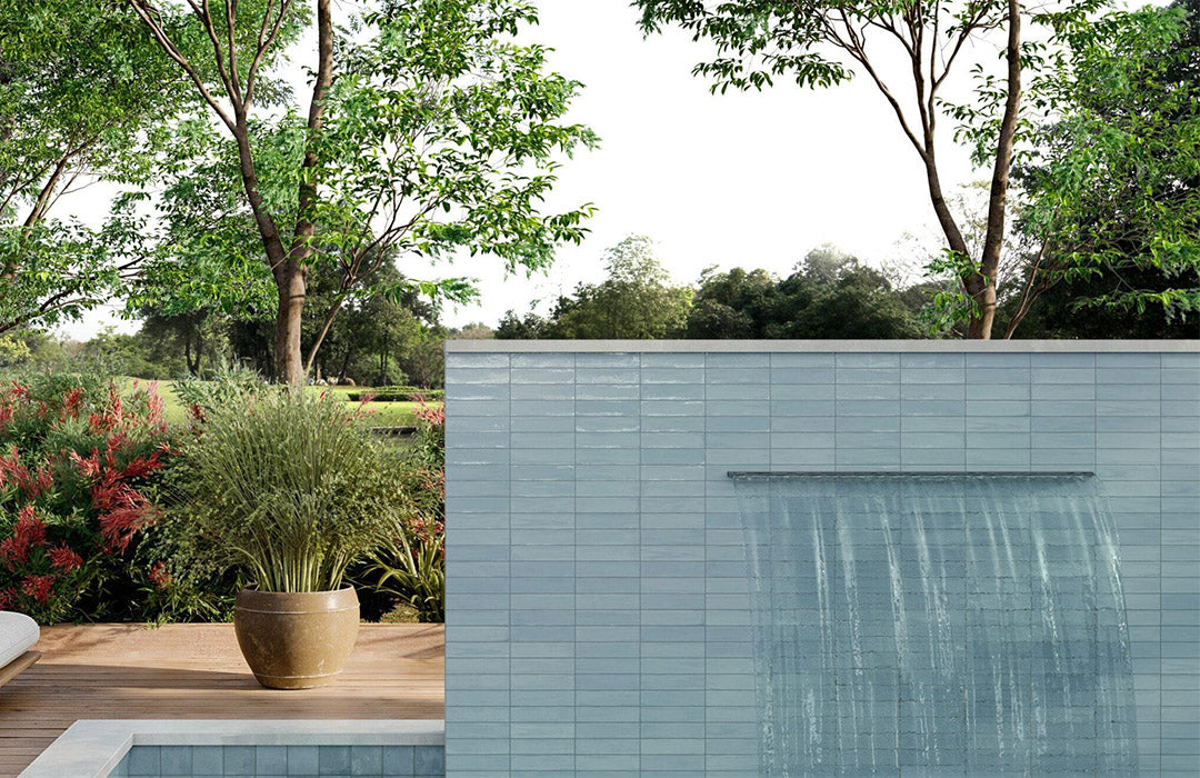 Modern building exterior with a pool and greenery