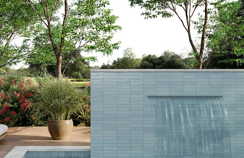 Modern building exterior with a pool and greenery