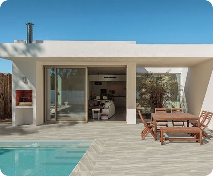 Modern house exterior with pool, deck, and outdoor furniture
