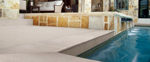 Beige porcelain pavers and swimming pool coping