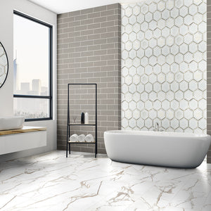 White hexagon tile on bathroom shower wall with soaking tub, stone-like porcelain floor tile, and gray subway tile on bathroom accent wall