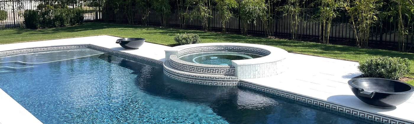 Greek key waterline tile on outdoor swimming pool