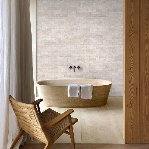 Beige ledger stone tile on bathroom wall with soaking tub