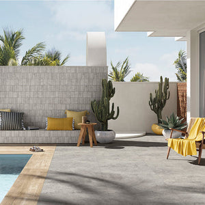 Outdoor living space with swimming pool, gray porcelain pavers, and patio furniture