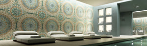 Multicolor custom mosaic tile mural on indoor swimming pool accent wall with white daybeds on the patio