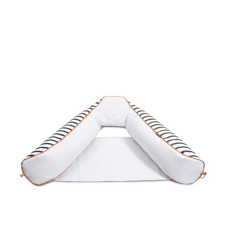 White pillow with black and gold accents on a white background