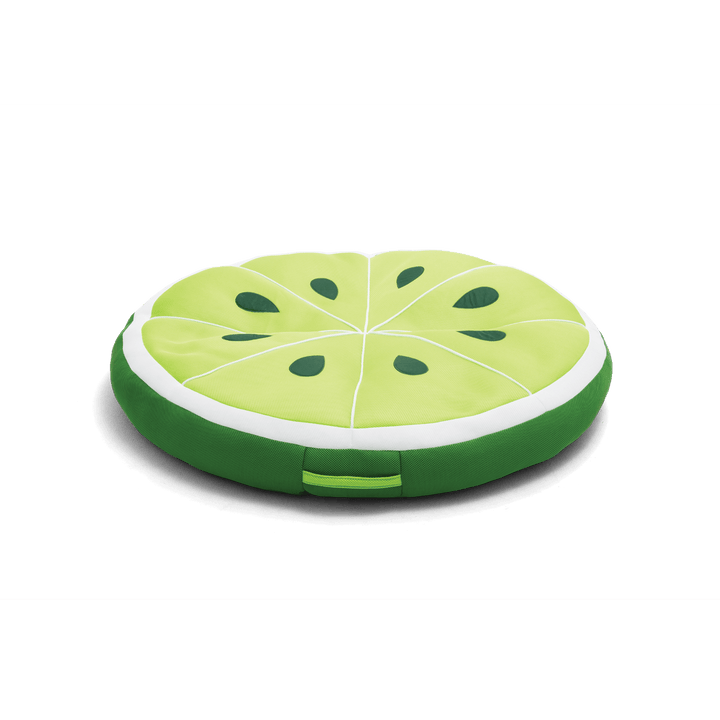 Round green cushion shaped like a watermelon slice on a black background