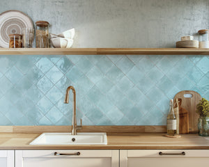 Kitchen with light blue tiled backsplash, wooden shelves, and countertops.