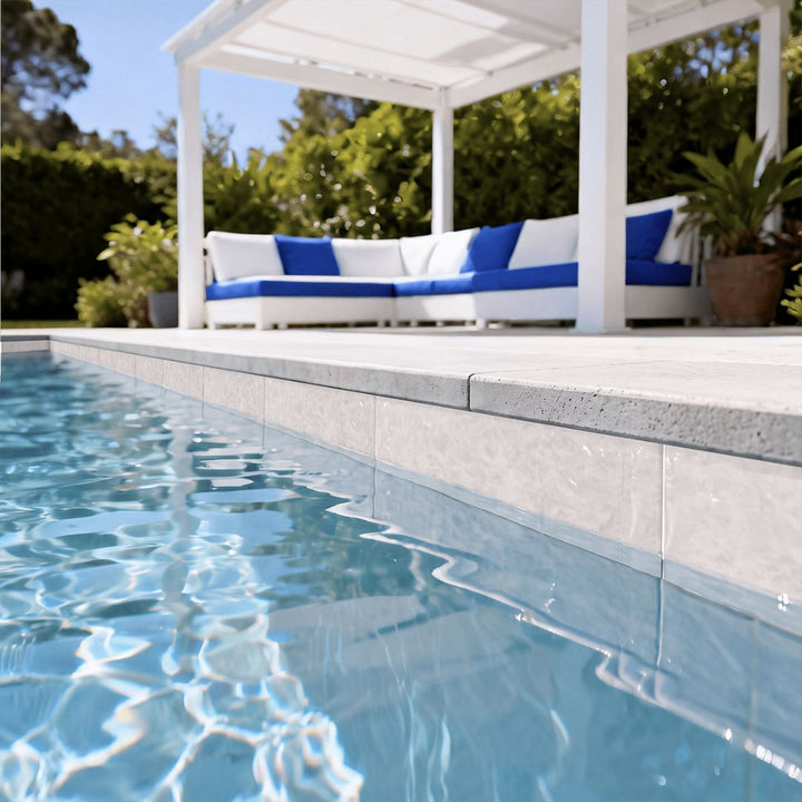Alps White porcelain pool tile with outdoor furniture in the background