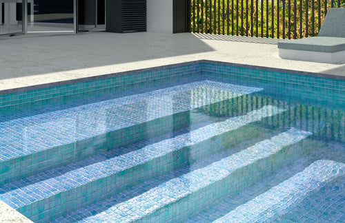 aqua pool tiles covering stairs in a pool