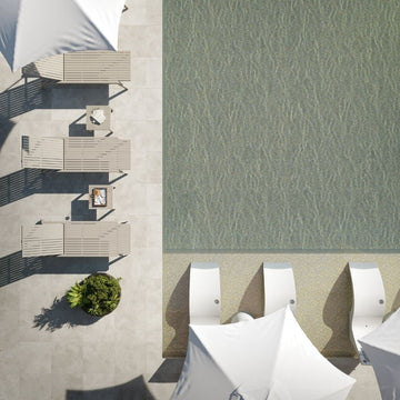 Top-down view of outdoor furniture by a pool with water pattern.