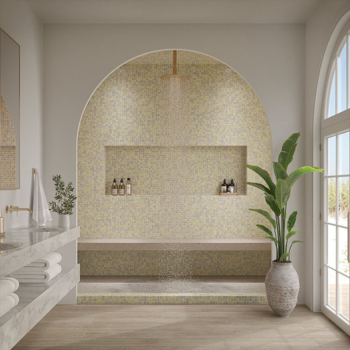 Modern bathroom with mosaic tile wall, plant, and natural light
