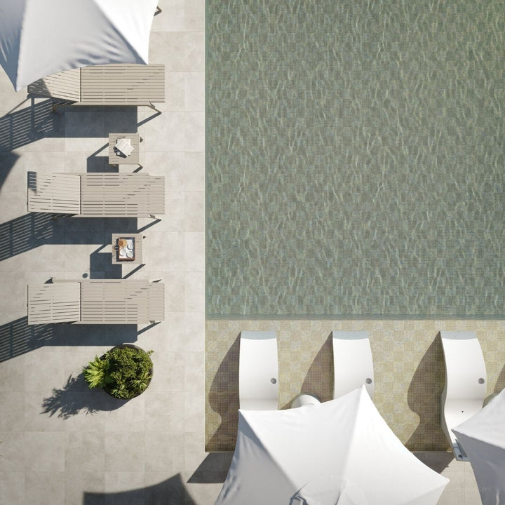 Top-down view of outdoor furniture and a pool with a textured wall.