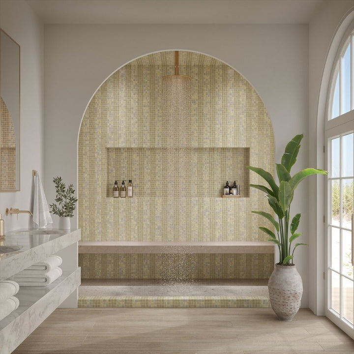 Modern bathroom with mosaic tile wall, plant, and natural light