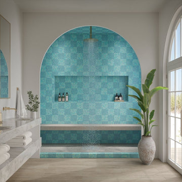 Modern bathroom with a blue tiled alcove and natural light