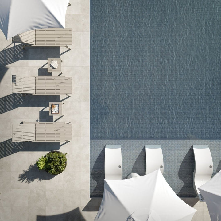 Top-down view of outdoor furniture by a pool with water pattern.