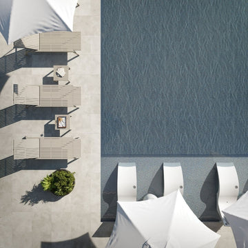 Top-down view of outdoor furniture by a pool with water pattern.