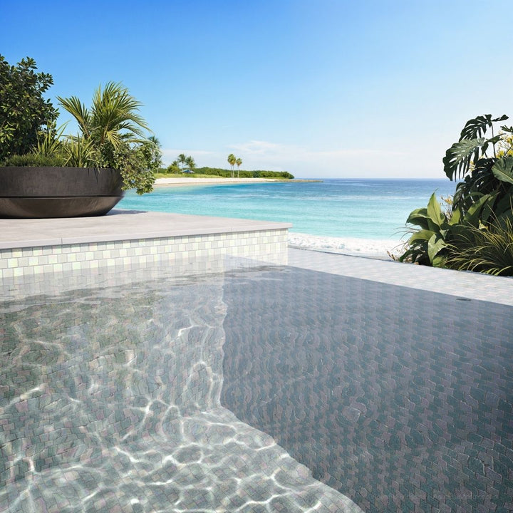 Pool area with tiled edge and ocean view