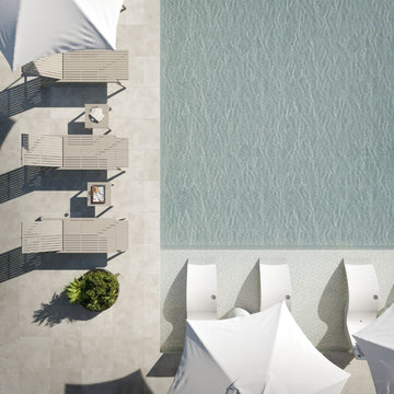 Top-down view of outdoor furniture by a pool with water pattern.