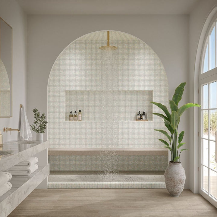 Modern bathroom with mosaic tile wall, plant, and natural light
