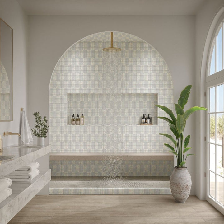 Modern bathroom with mosaic tile wall, plant, and natural light