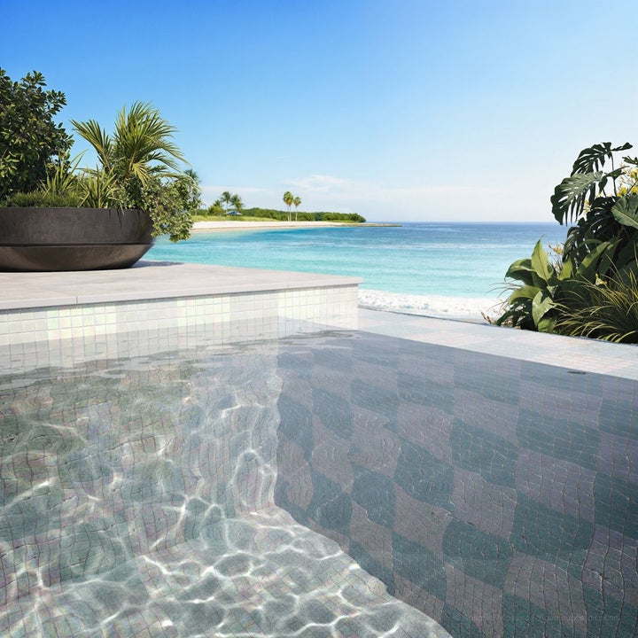 Pool area with tiled edge and ocean view