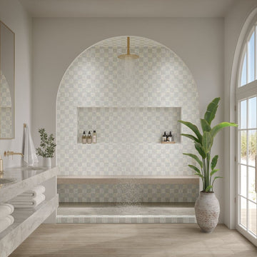 Modern bathroom with mosaic tile wall, plant, and natural light