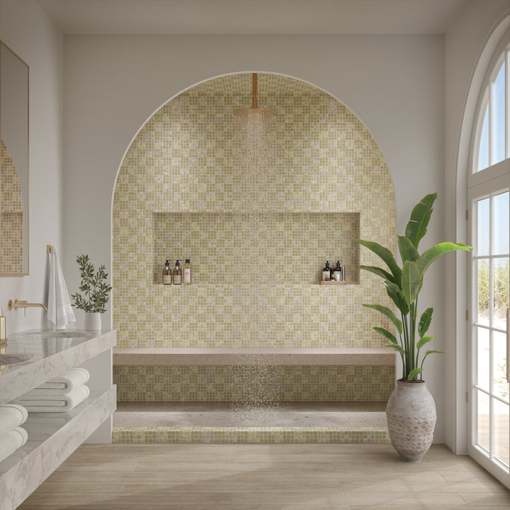 Modern bathroom with mosaic tile wall, plant, and natural light