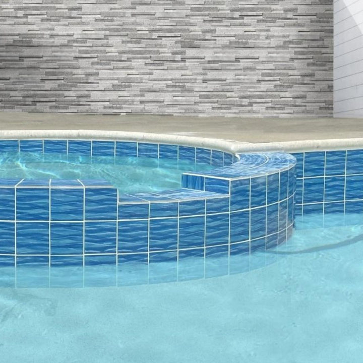 A set of four blue porcelain pool tiles with a wavy pattern.