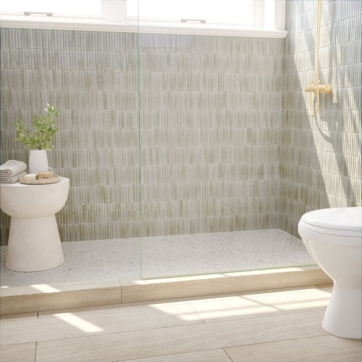 Modern bathroom with tiled walls, a toilet, and a sink.