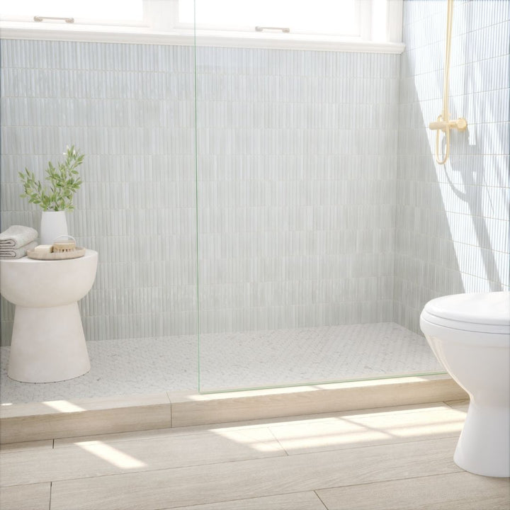 Modern bathroom with white toilet, sink, and decorative elements.