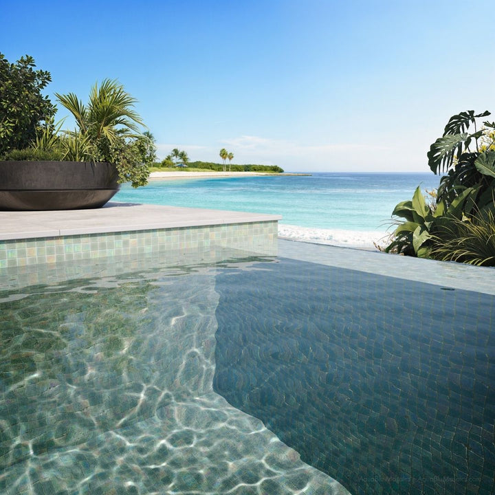 Pool area with tiled edge and ocean view