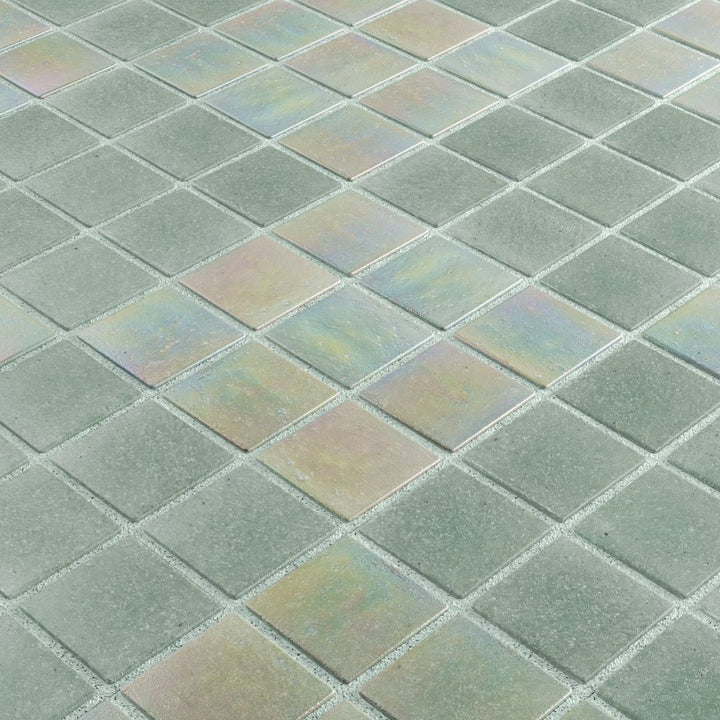 Close-up of iridescent glass mosaic tiles in a grid pattern