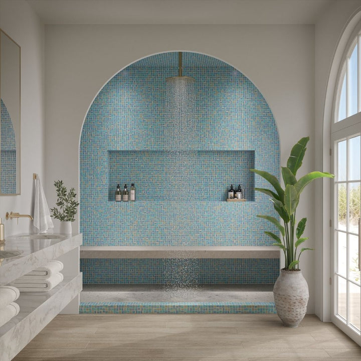 Modern bathroom with mosaic tile wall, plant, and natural light