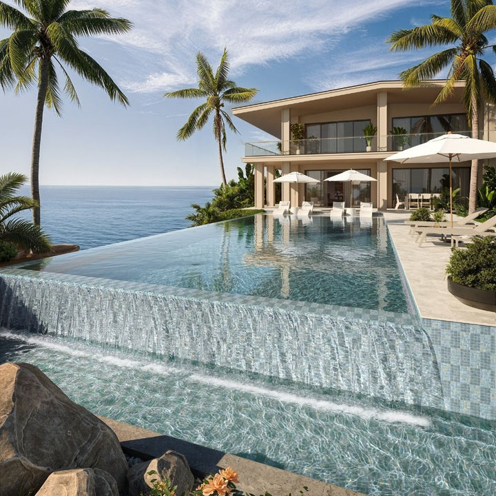 Luxury villa with an infinity pool overlooking the ocean, surrounded by palm trees.