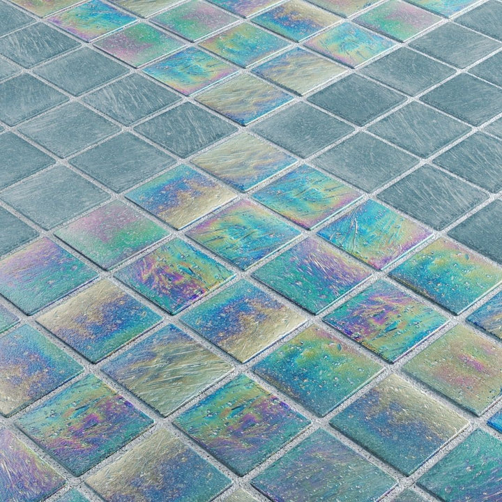 Close-up of iridescent glass mosaic tiles in various shades of blue and green.