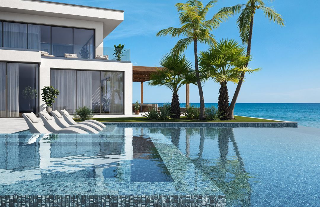 Blue mosaic glass tile in swimming pool with chairs and palm trees