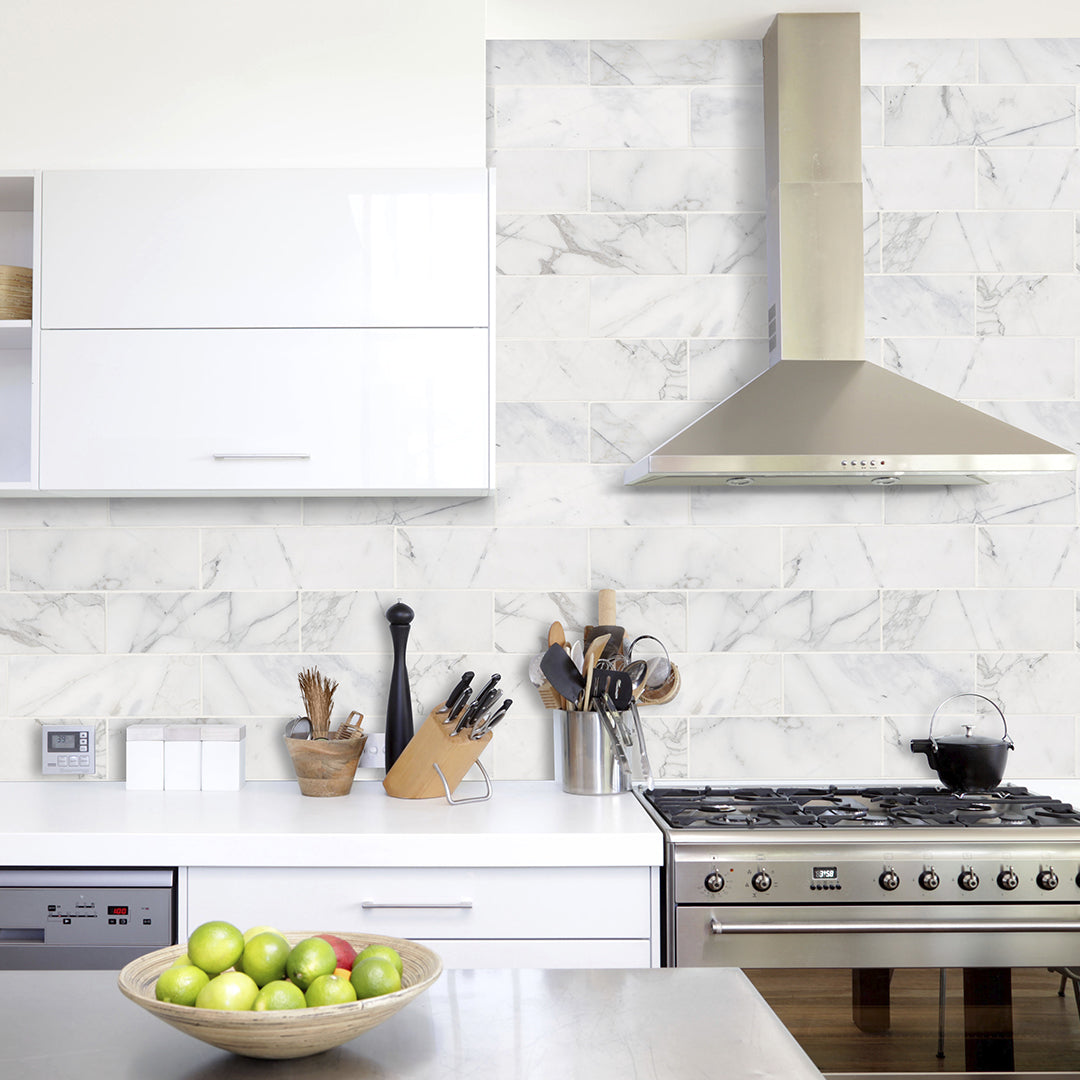 White and gray natural stone subway tile on kitchen backsplash