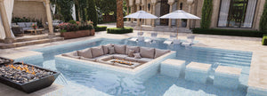 Outdoor pool area with lounge seating and fire pit in a luxurious setting
