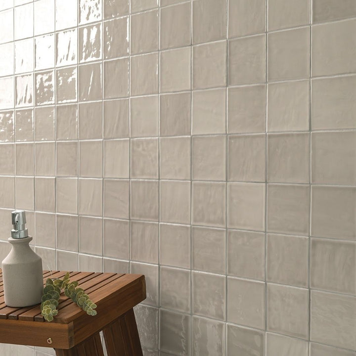 Terranello Dune 4" x 4" Glossy Kitchen Backsplash Tile with a stool and soap.