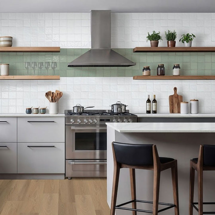Terranello Olive 4" x 4" Glossy Kitchen & Bathroom Tile with a stove, bottles, utensils and barstools