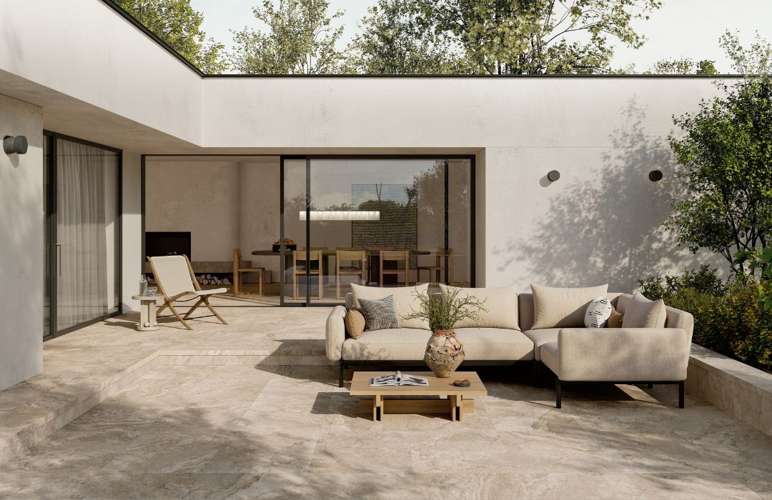 Tuscan Series Porcelain with an outdoor couch, plant, and chair