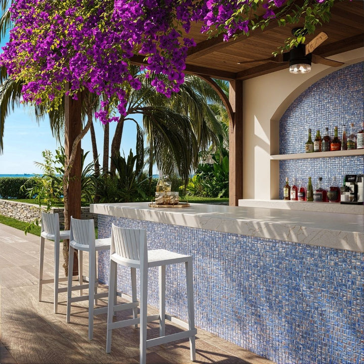 blue mosaic glass tile in outdoor and kitchen and bar area with barstools