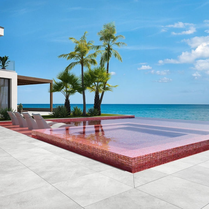 red mosaic glass tile in swimming pool with chairs and palm trees