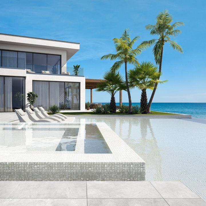 white mosaic glass tile in swimming pool with chairs and palm trees