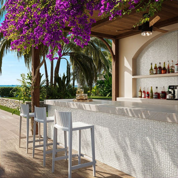 white mosaic glass tile in outdoor and kitchen and bar area with barstools