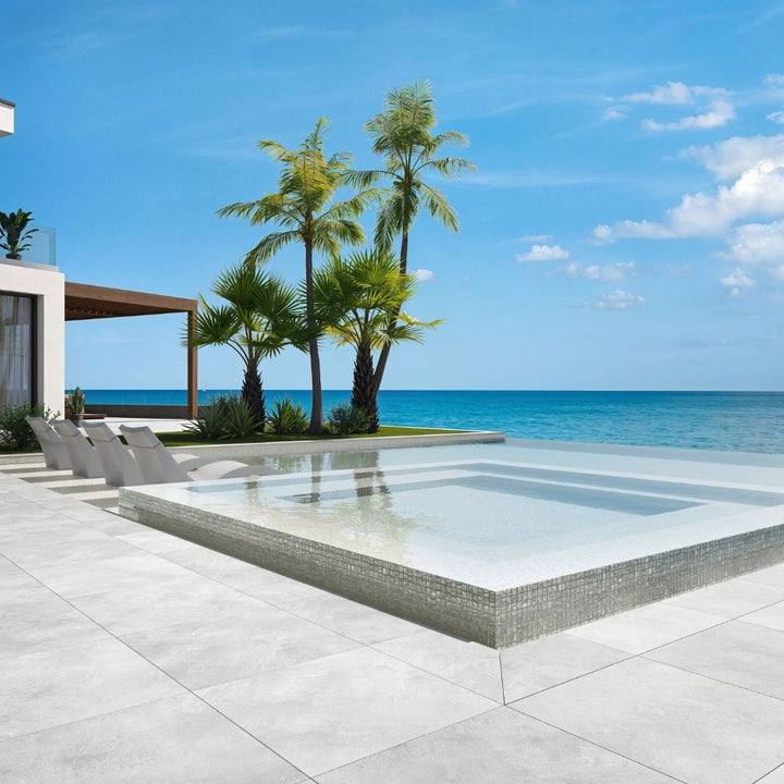 white mosaic glass tile in swimming pool with chairs and palm trees