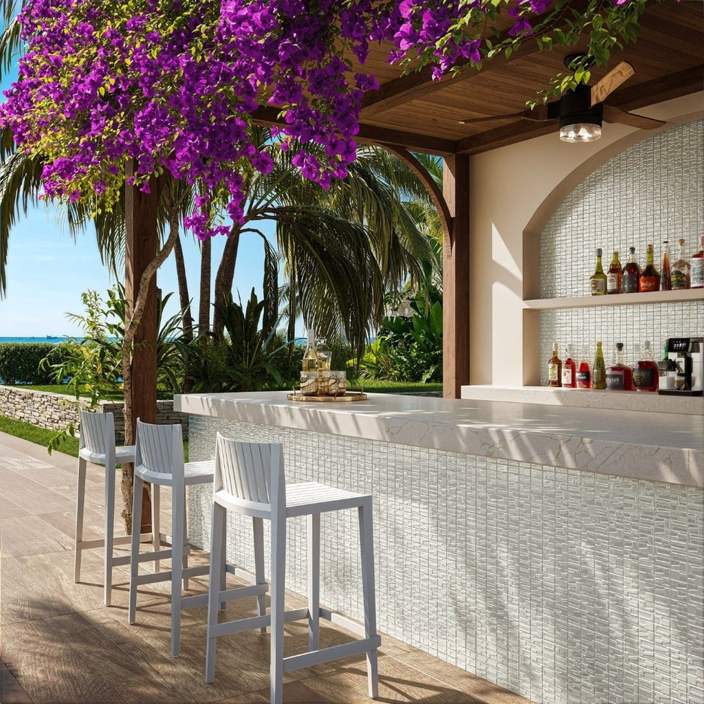 white mosaic glass tile in outdoor and kitchen and bar area with barstools