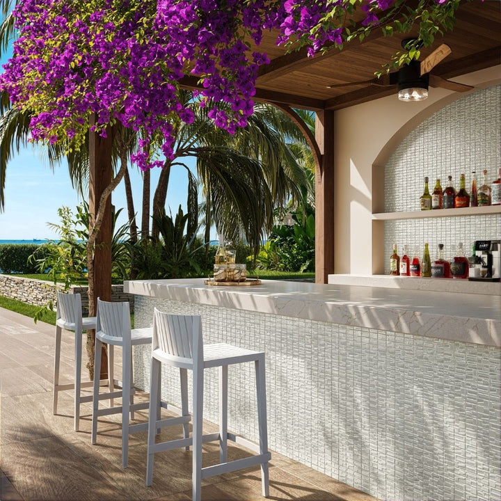 white mosaic glass tile in outdoor and kitchen and bar area with barstools