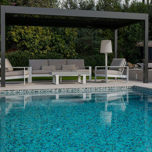 Outdoor living space with an all glass tile swimming pool and outdoor patio furniture